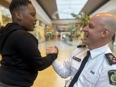 The deputy chief high fiving a youth